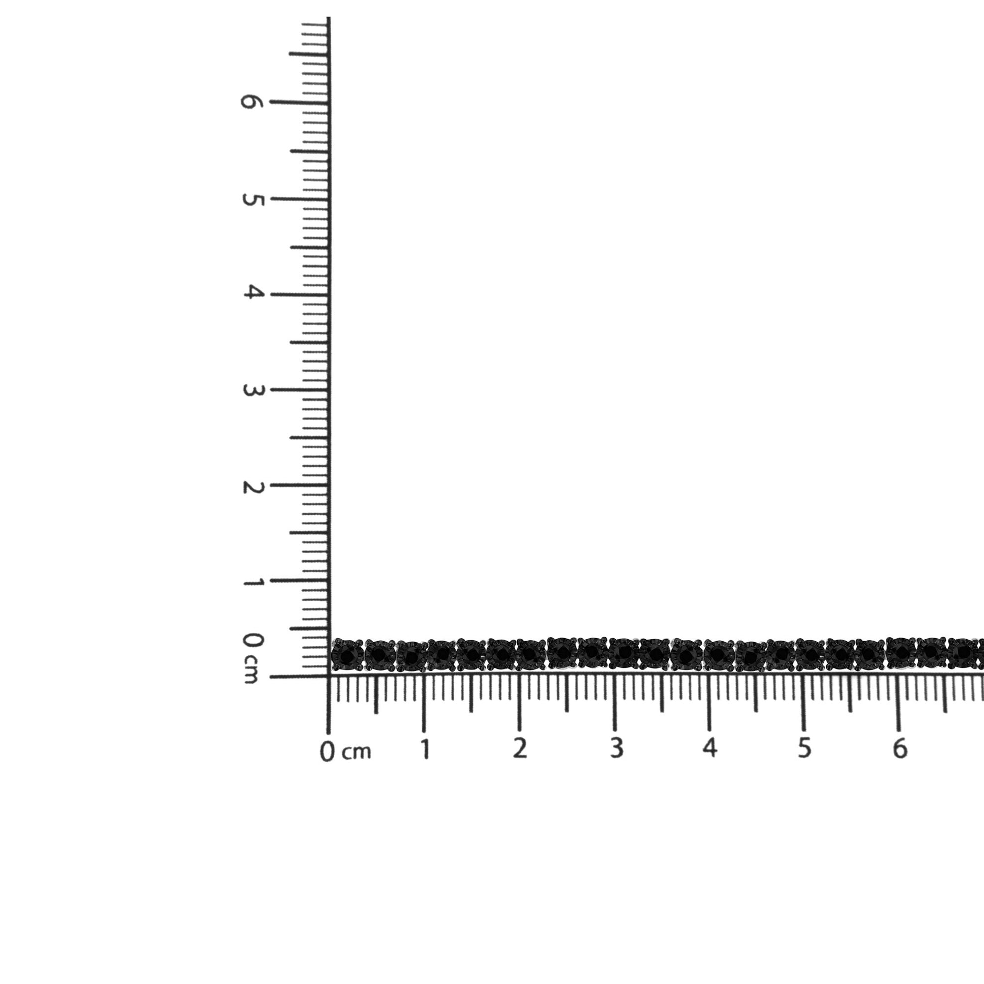White bracelet with round black gemstones in miracle setting, displayed flat on a ruler for size reference, top-down angle.
