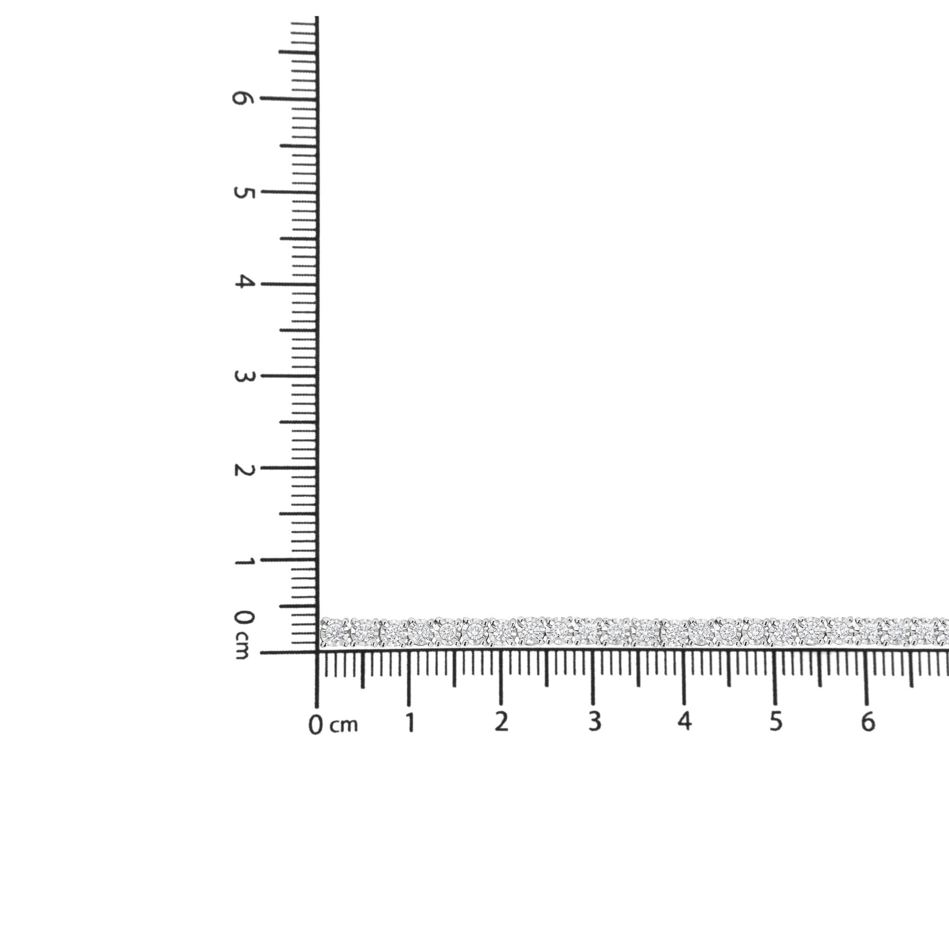 White metal bracelet with round white gemstones in miracle setting, displayed on a ruler for size reference, top-down angle.