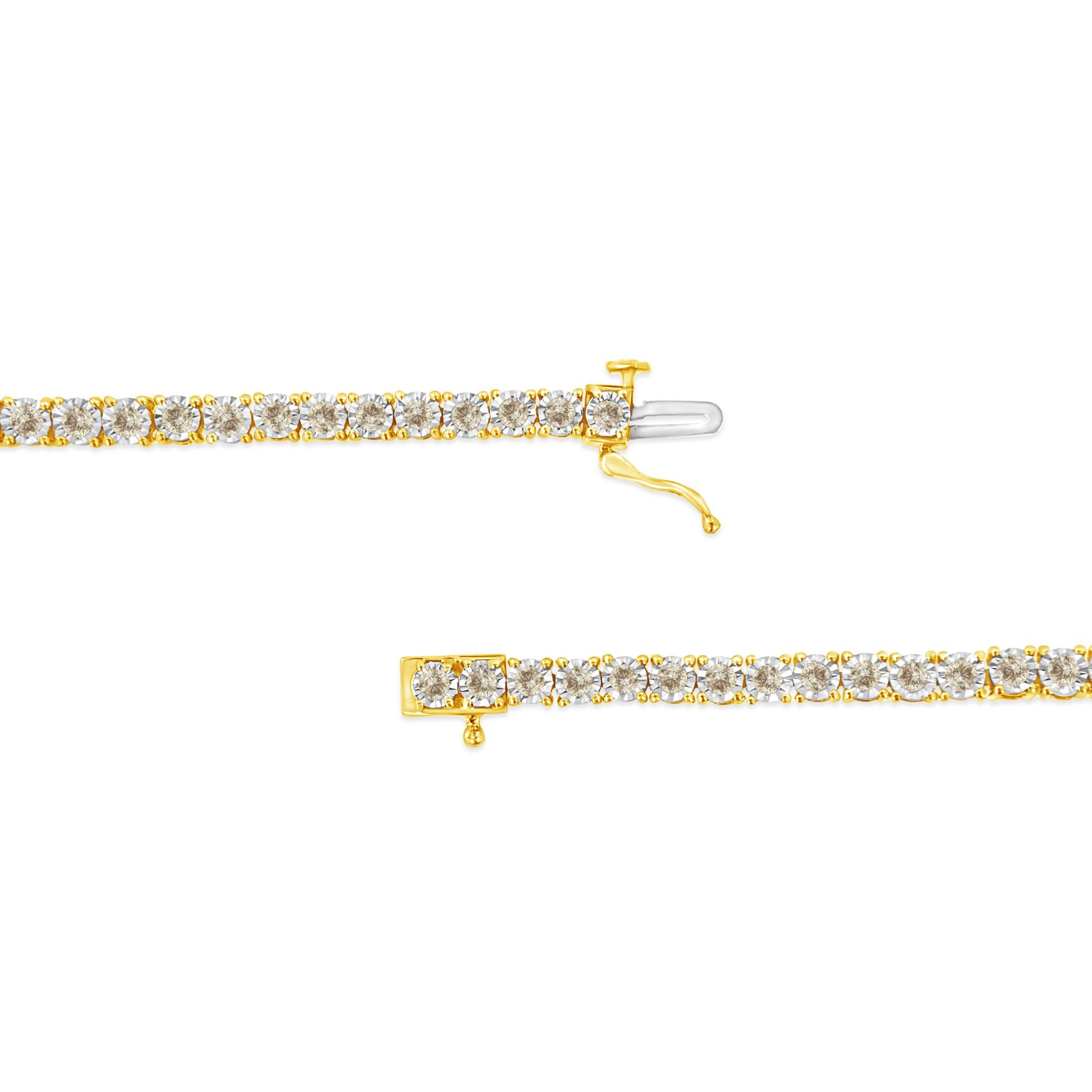 Close-up front angle of a yellow metal bracelet set with round brownish gemstones in a miracle setting, shown unclasped on a white background.
