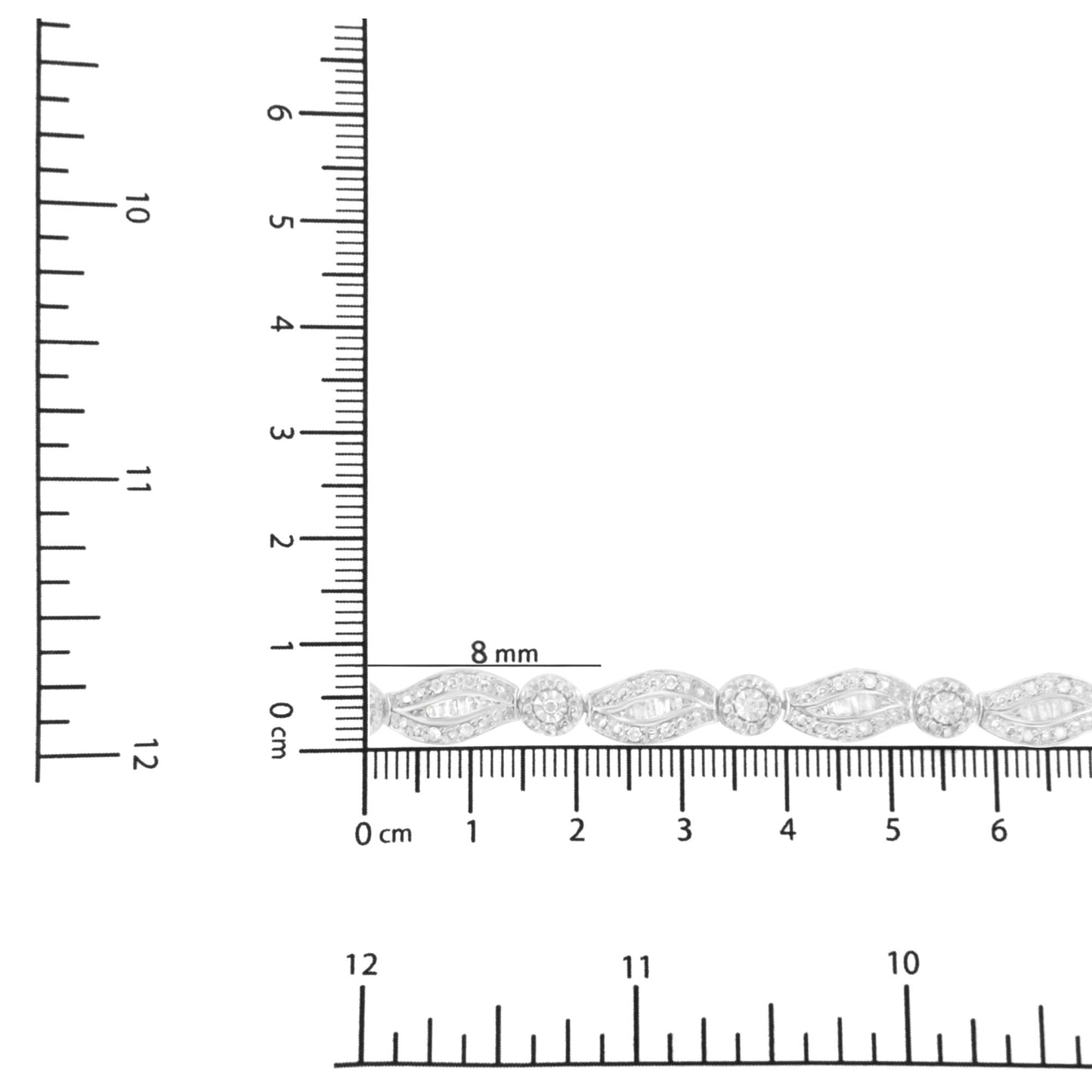 Close-up shot of a white metal bracelet with alternating round prong-set white gemstones and baguette channel-set white gemstones, displayed on a ruler for size reference.