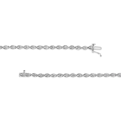 Top-down view of two white metal bracelets with round white gemstones in miracle settings, each featuring a series of linked teardrop shapes.