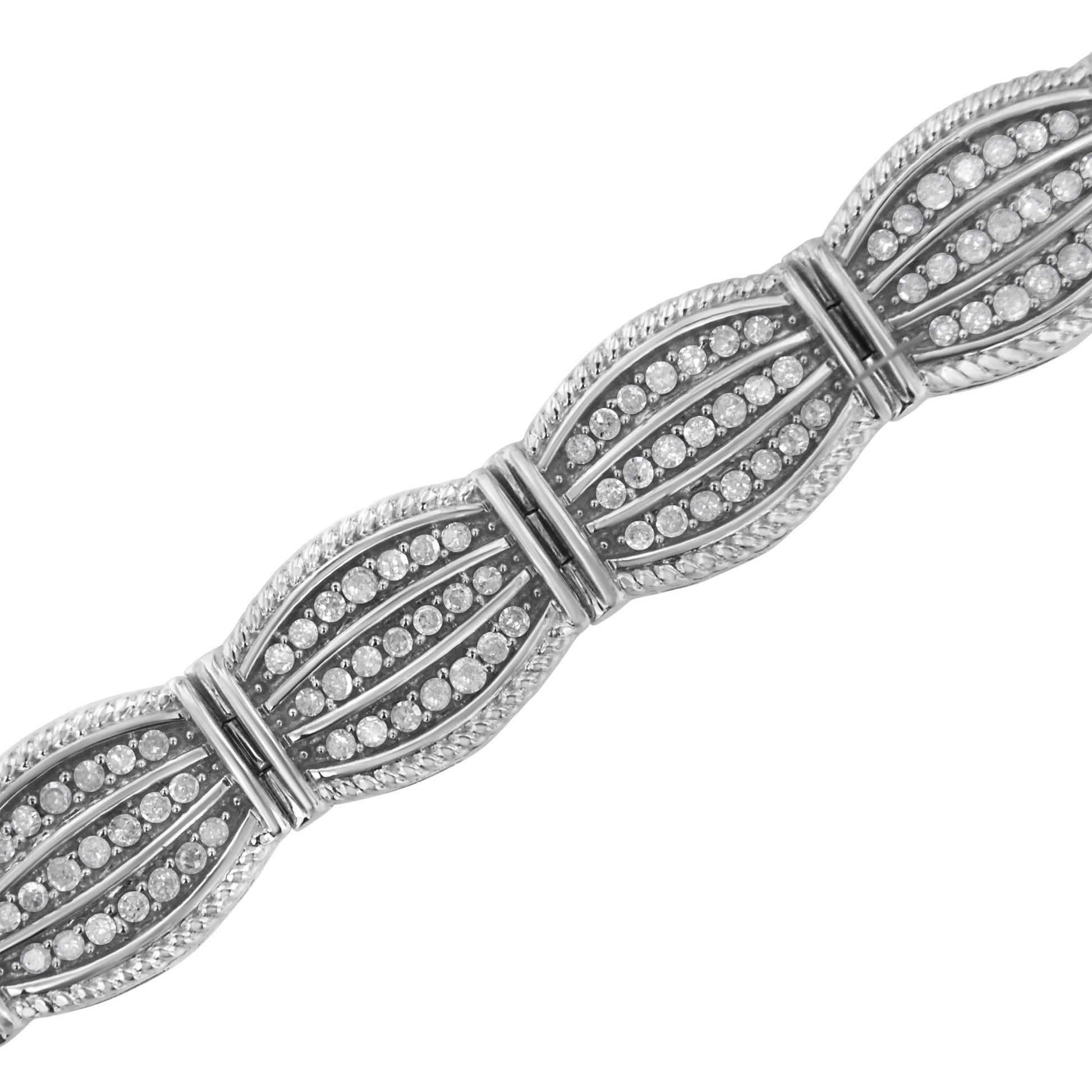 Diagonal close-up of a white metal bracelet with sections featuring rows of round white gemstones in prong settings.