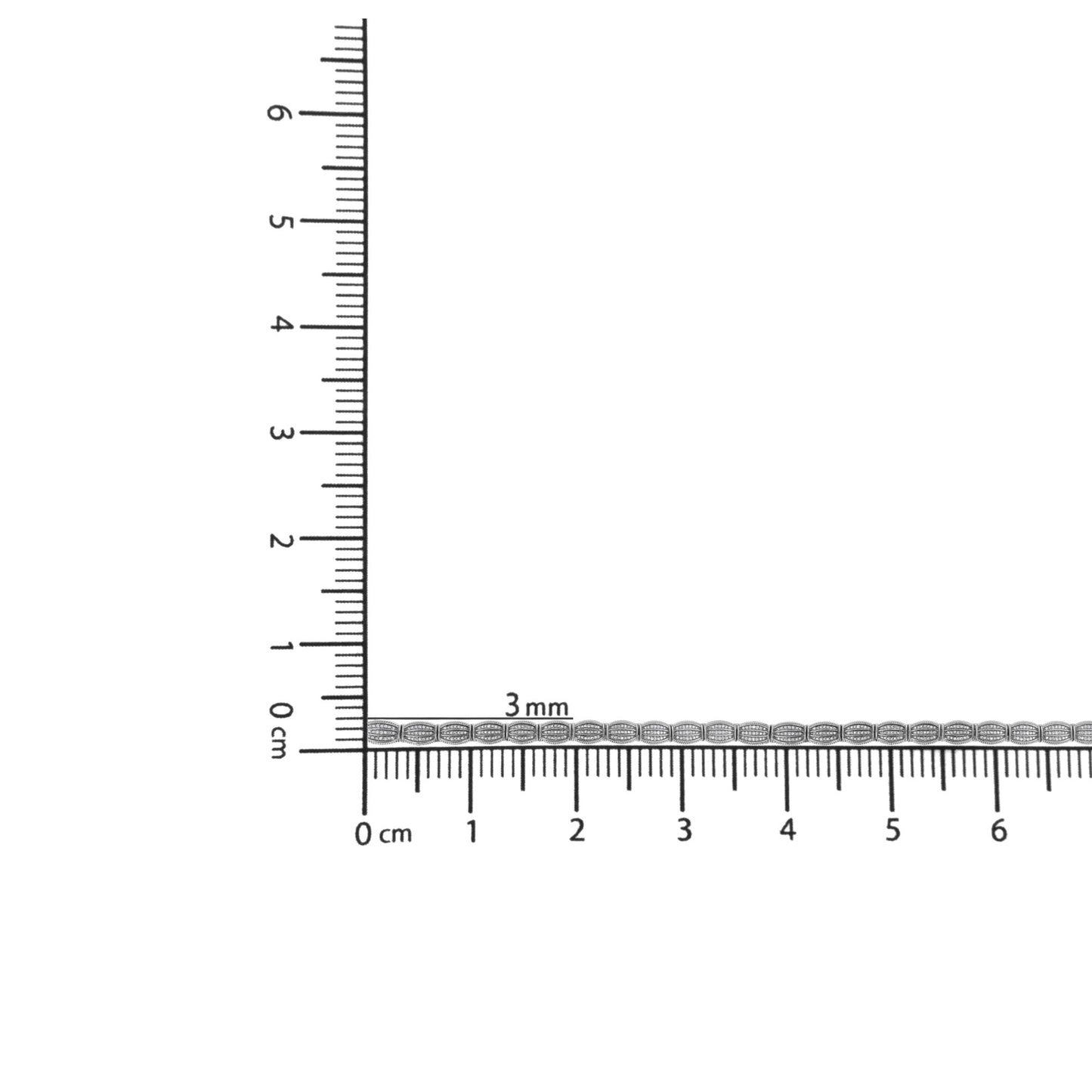 Close-up image of a white metal bracelet with round white gemstones in prong settings, displayed horizontally on a ruler for size reference.