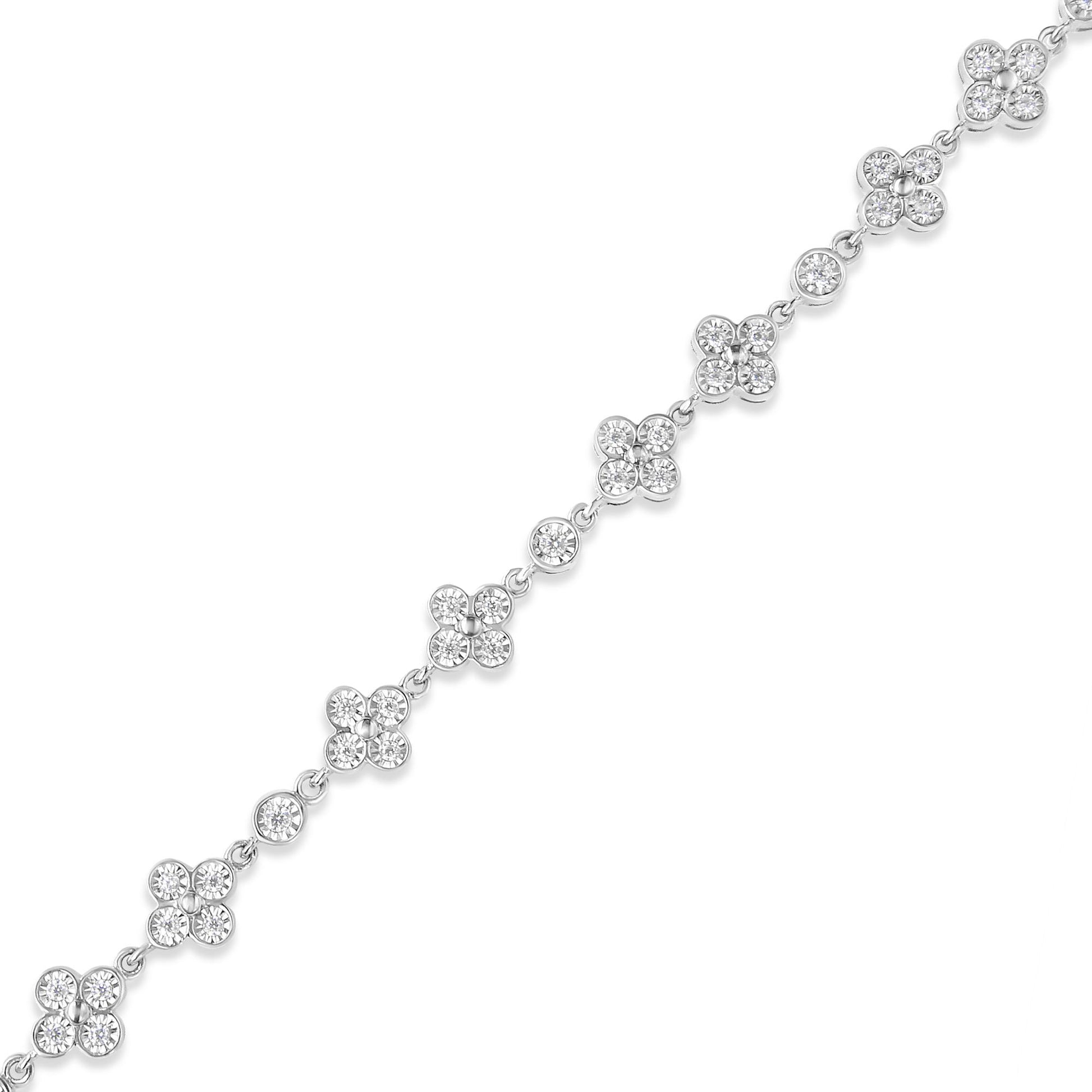 White metal bracelet with round white gemstones in cluster and single settings, shown in a diagonal top-down view.