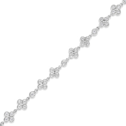 White metal bracelet with round white gemstones in cluster and single settings, shown in a diagonal top-down view.