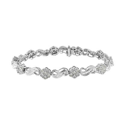 White metal bracelet with alternating flower and infinity-shaped links adorned with round and baguette white gemstones, shown from a front angle.