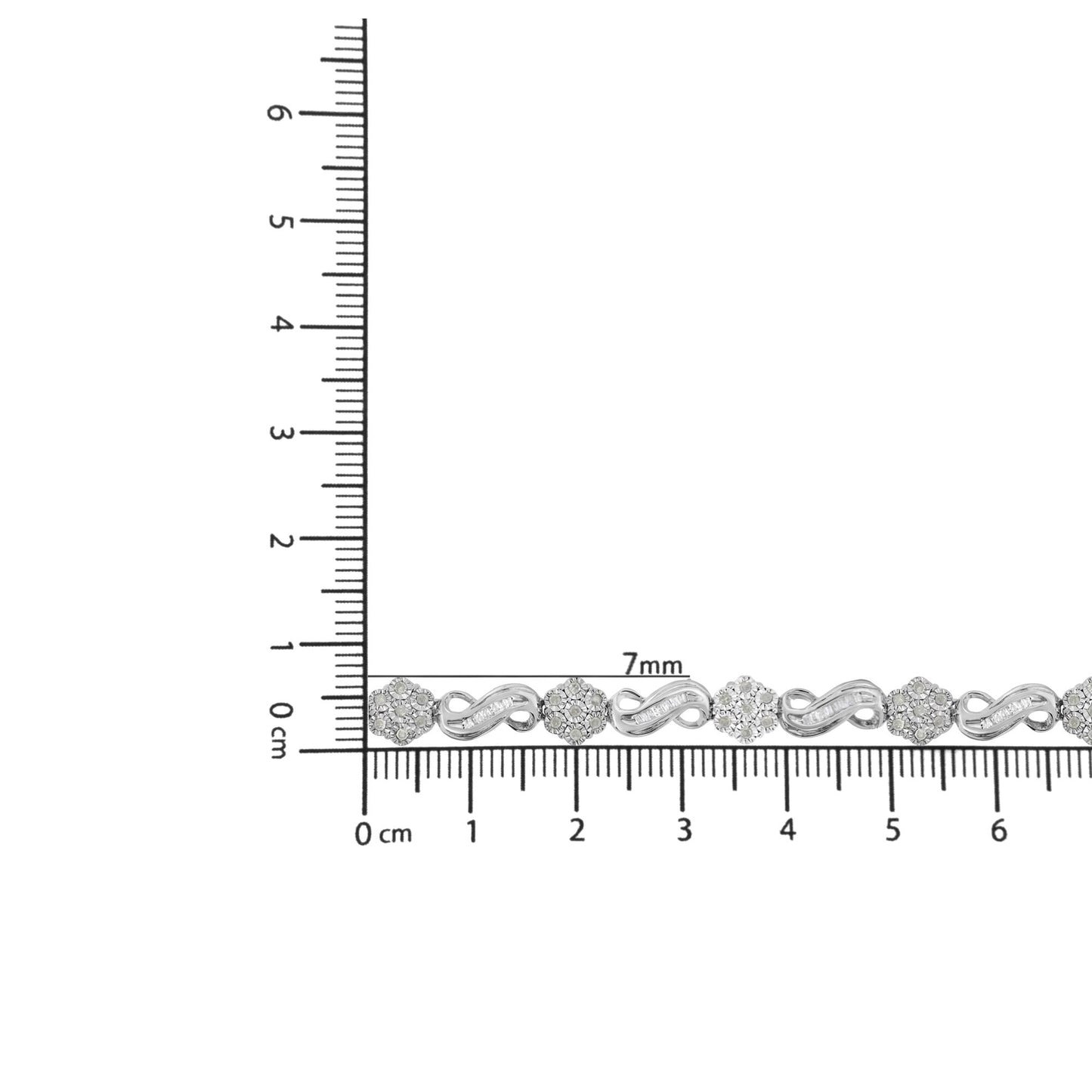 Bracelet with white metal, round and baguette-shaped white gemstones, shown on a ruler for size reference from a top-down angle.