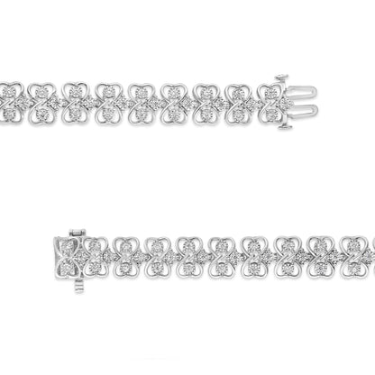 Top-down view of a white metal bracelet featuring linked heart-shaped designs with round white gemstones in a miracle setting.