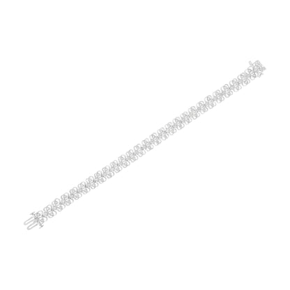 White metal bracelet with a repeating round shaped white gemstones in a miracle setting, shown flat at an angle.