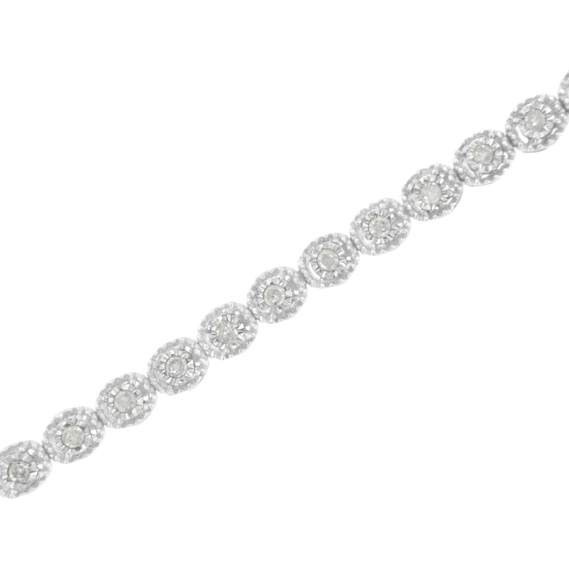 White metal bracelet with round white gemstones in a miracle setting, shown in a diagonal close-up view.