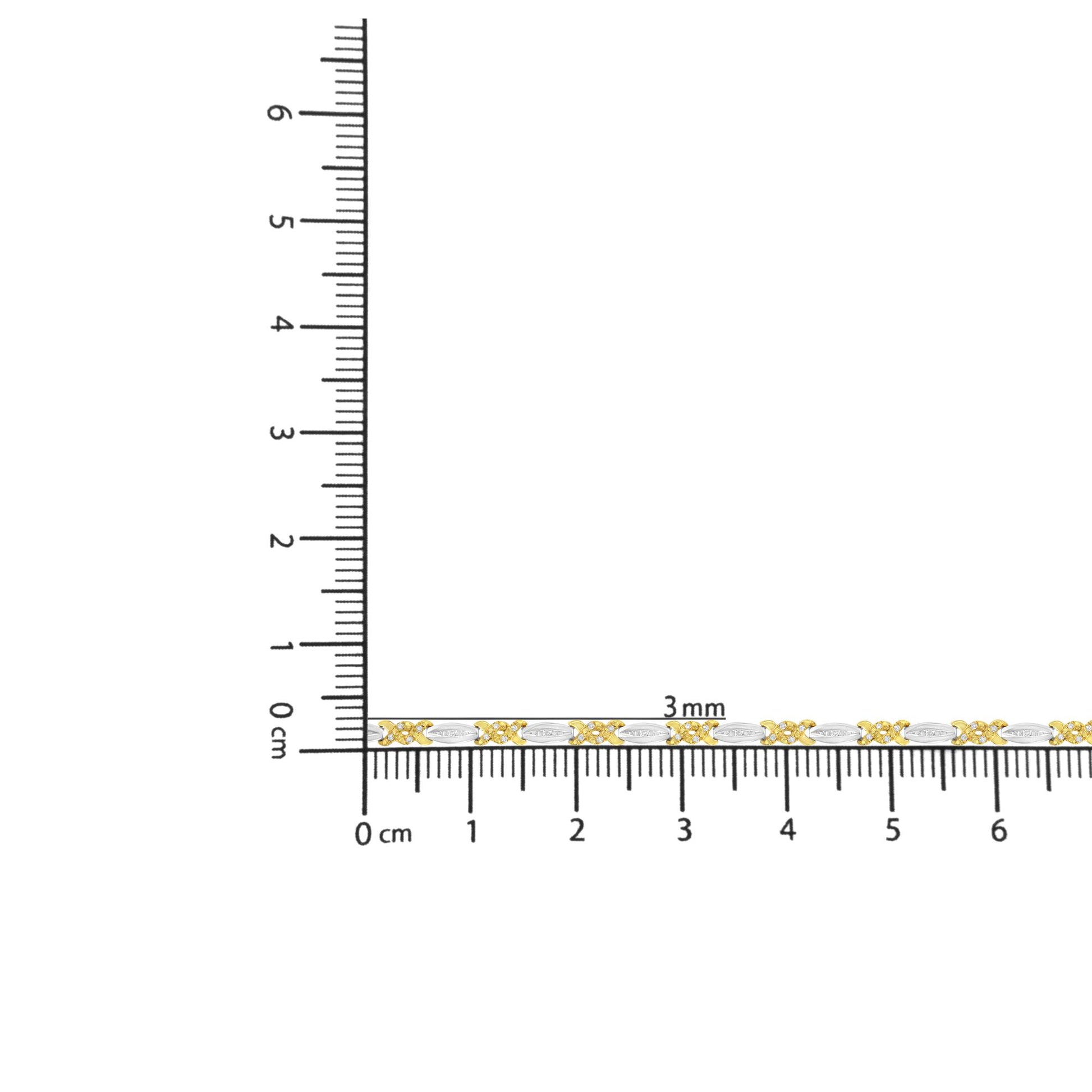 Bracelet with alternating yellow and white metal links accented with round white gemstones in channel setting, shown close-up on a ruler for size reference.