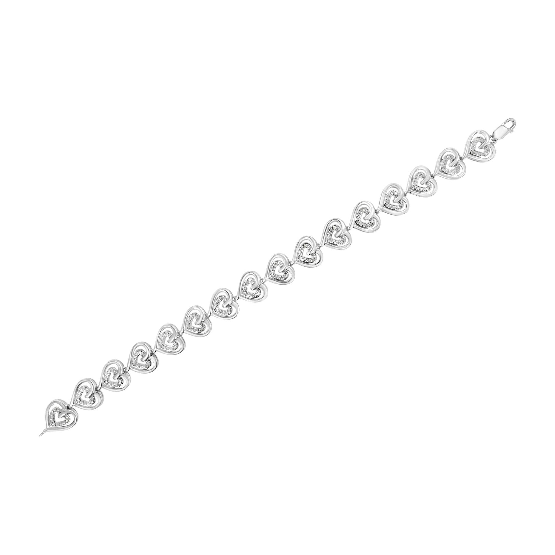 White metal bracelet with linked heart shapes, each heart containing white gemstones in prong settings, shown from a top-down angle.