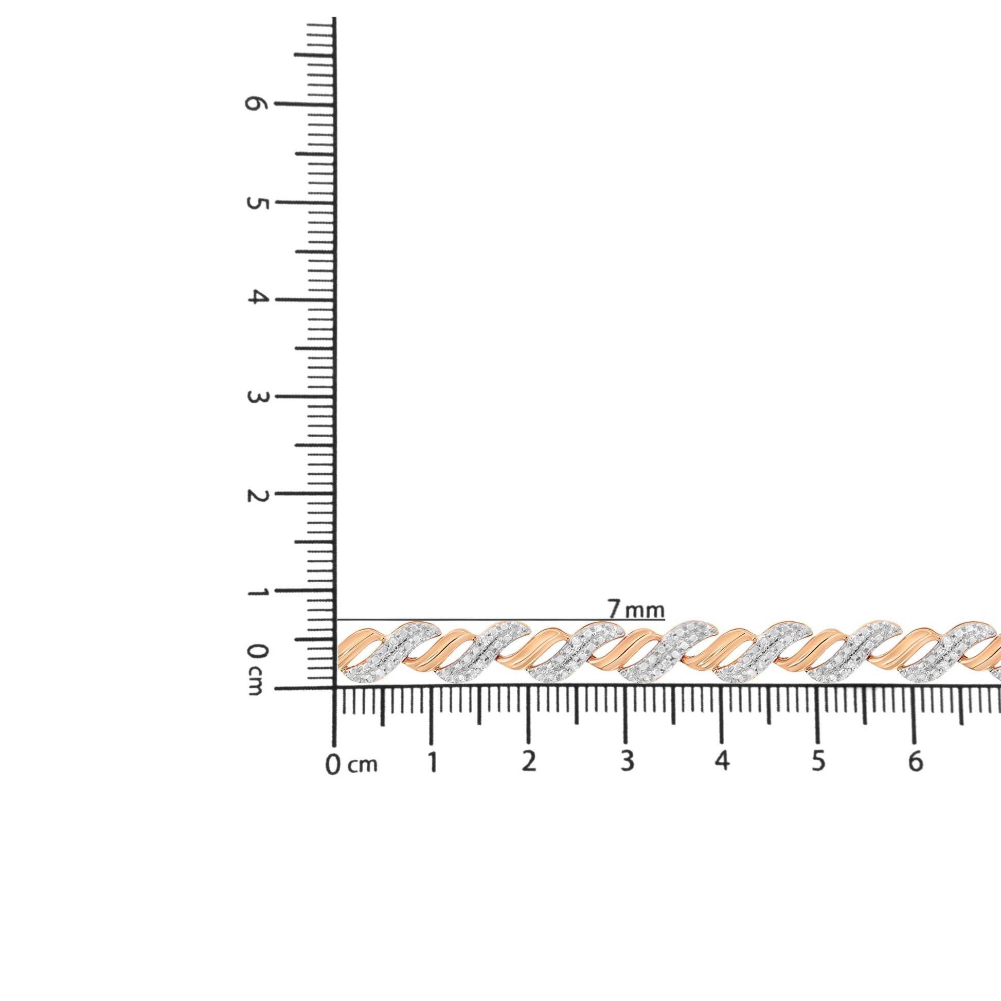 Close-up front view of a rose-colored bracelet with alternating smooth and white gemstone-studded twisted links, placed on a ruler for size reference.