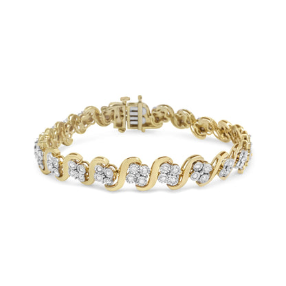 Yellow metal bracelet with alternating wave pattern and clusters of round white gemstones in a miracle setting, front angle view.