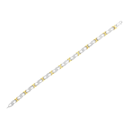 Bracelet with alternating yellow and white metal links, white round gemstones set in a channel setting on white links, shown at a slight angle.