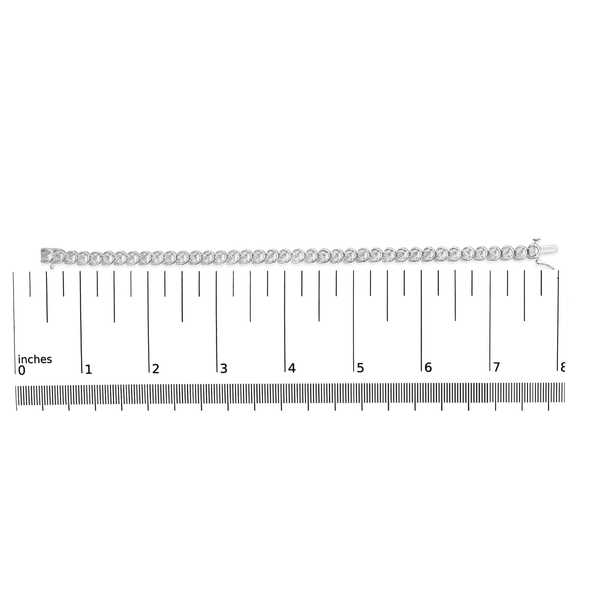 White metal bracelet with round white gemstones in miracle settings, laid flat on a ruler for size reference, shot from above.