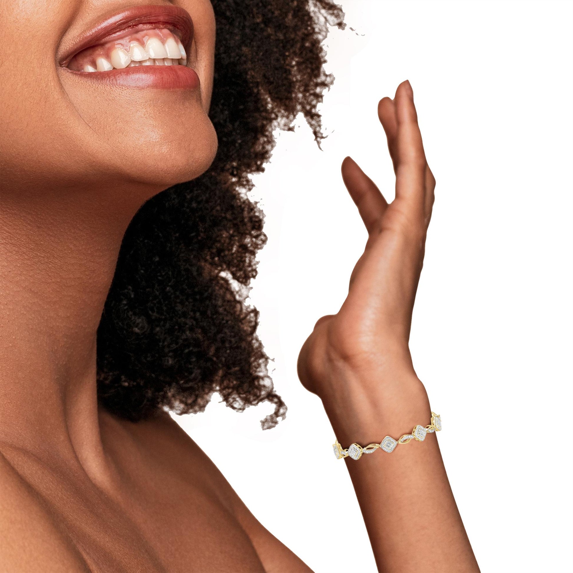 Yellow metal bracelet with prong-set white round gemstones, worn on model's wrist, side-angle view.
