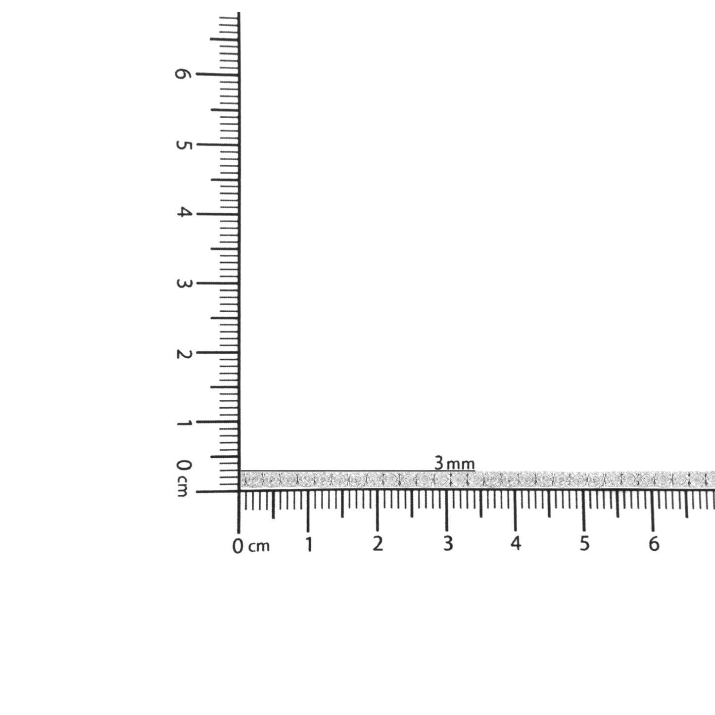 White metal bracelet with round white gemstones in miracle setting, shown in a close-up horizontal view on a ruler for size reference.