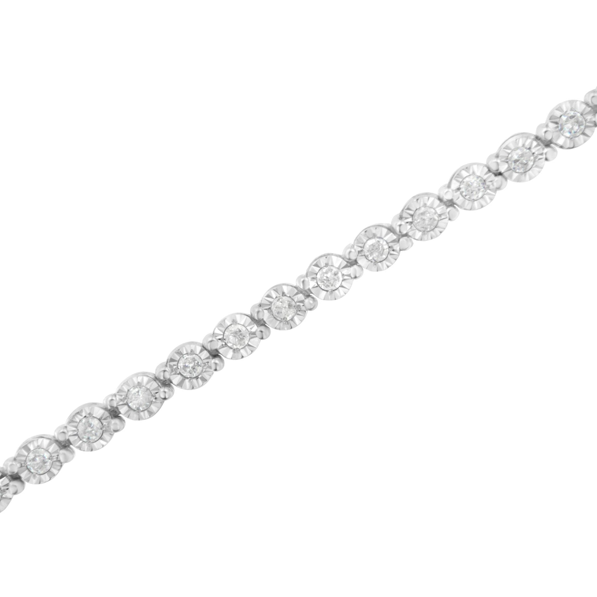 Diagonal close-up of a white metal bracelet featuring round white gemstones in a miracle setting.