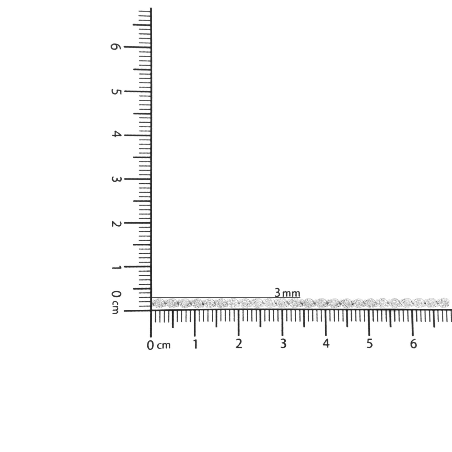 White metal bracelet with round white gemstones in miracle setting, laid flat on a ruler for size reference, top-down angle.