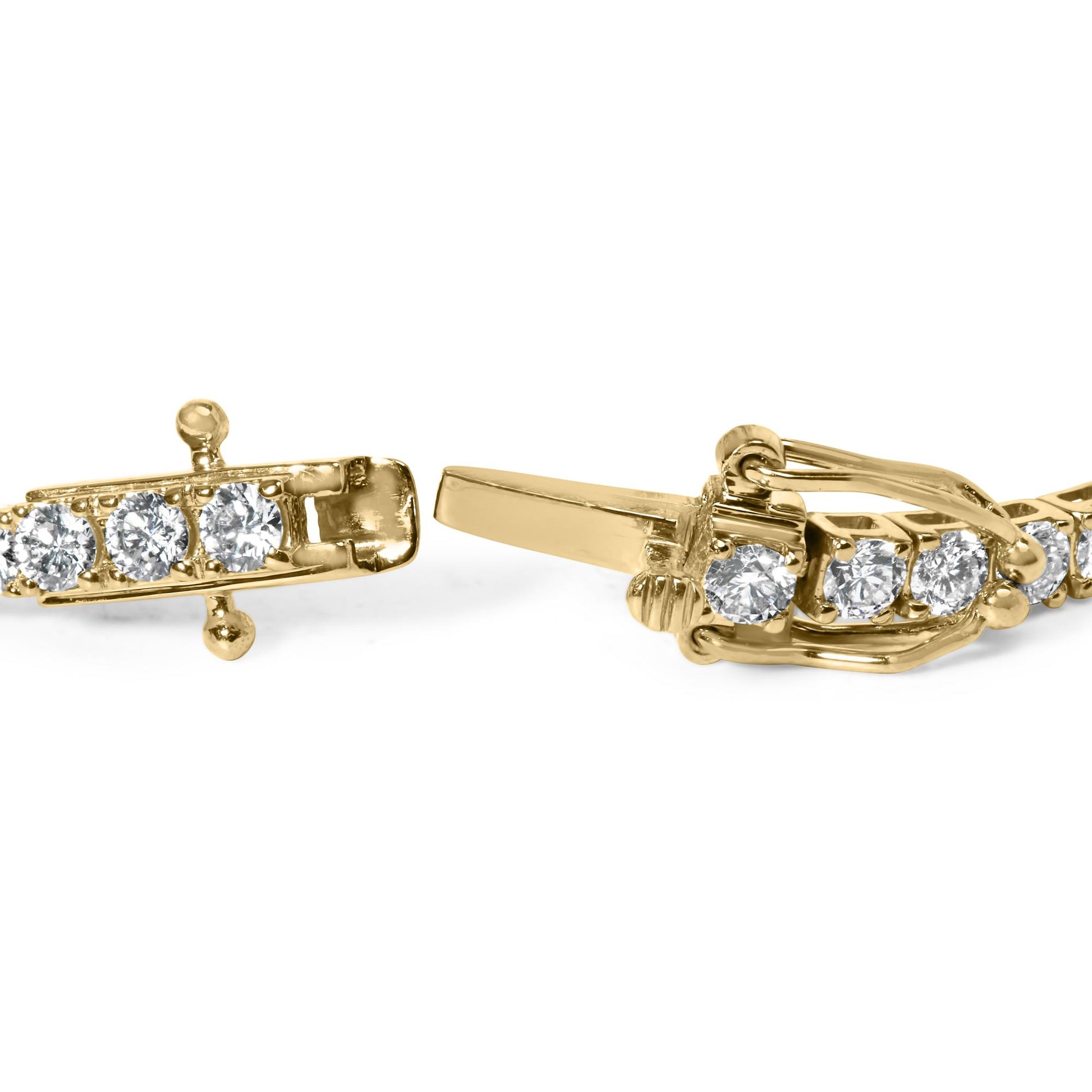 Close-up angled view of a yellow metal bracelet clasp with round white gemstones in 4-prong settings.