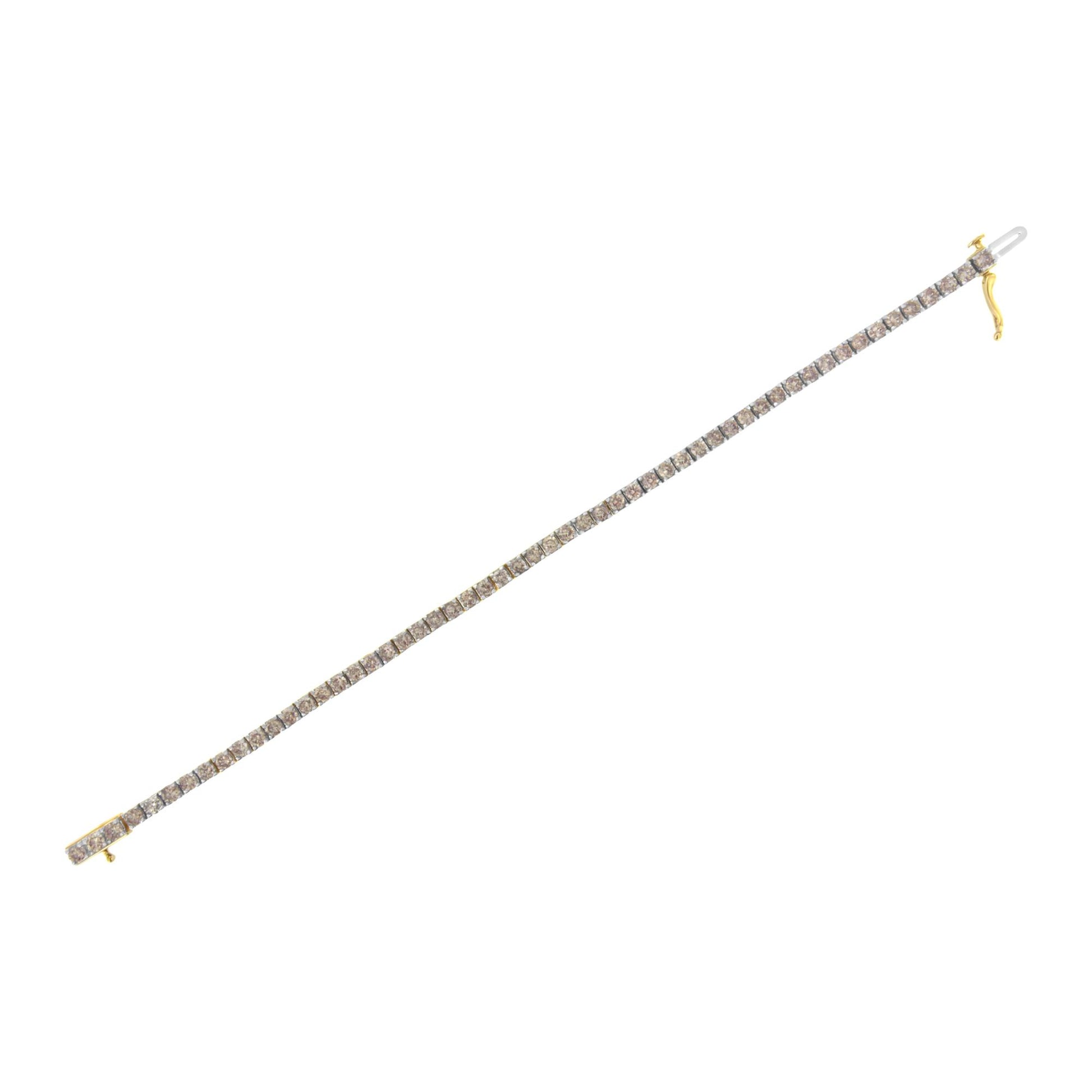 Straight-on top view of a yellow metal bracelet set with round white gemstones in a 4-prong setting, shown flat on a white background.