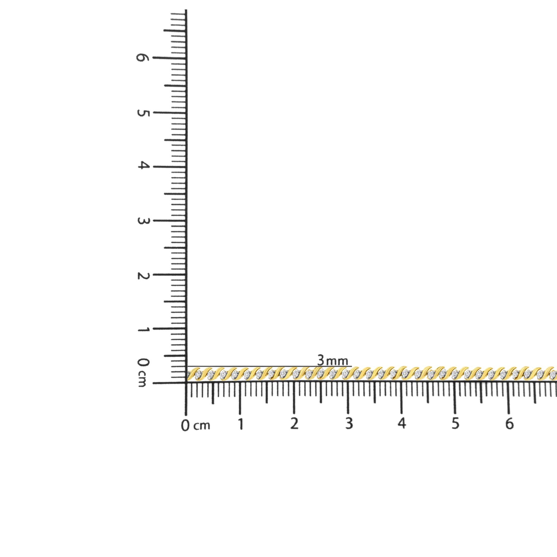 Yellow metal bracelet with round white gemstones in two-prong settings, shown on a ruler for size reference, top-down view.