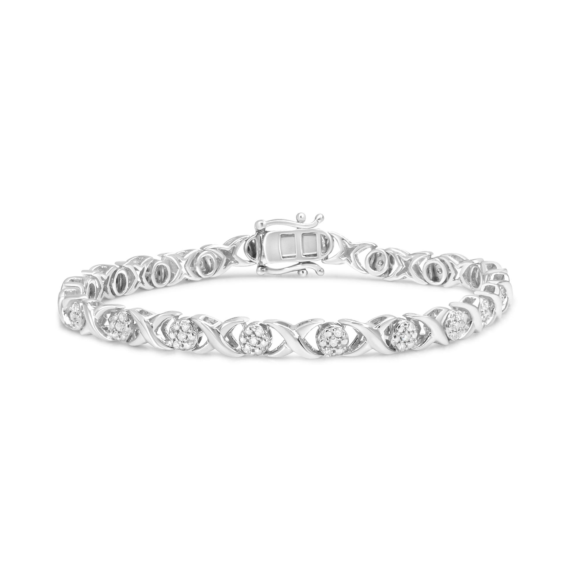 Bracelet in white metal with alternating round clusters of white gemstones set in prong settings, shown from a front angled view.