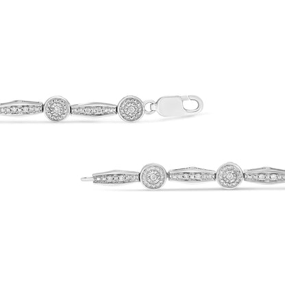 Close-up front view of a white metal bracelet with alternating round and elongated links, each adorned with white gemstones in two different settings, shown against a white background.