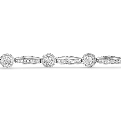 Close-up front view of a white metal bracelet featuring circular settings with round white gemstones in miracle settings and elongated sections with round white gemstones in pave settings.