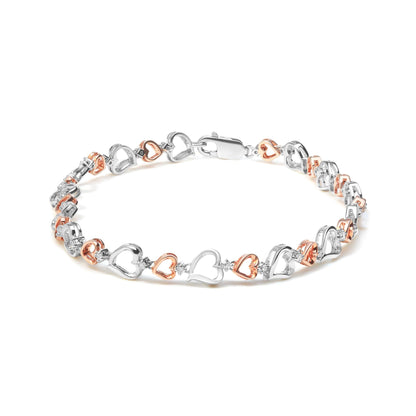 Bracelet with alternating white and rose heart-shaped links connected by small white gemstones, shown in a flat lay angled slightly from above.