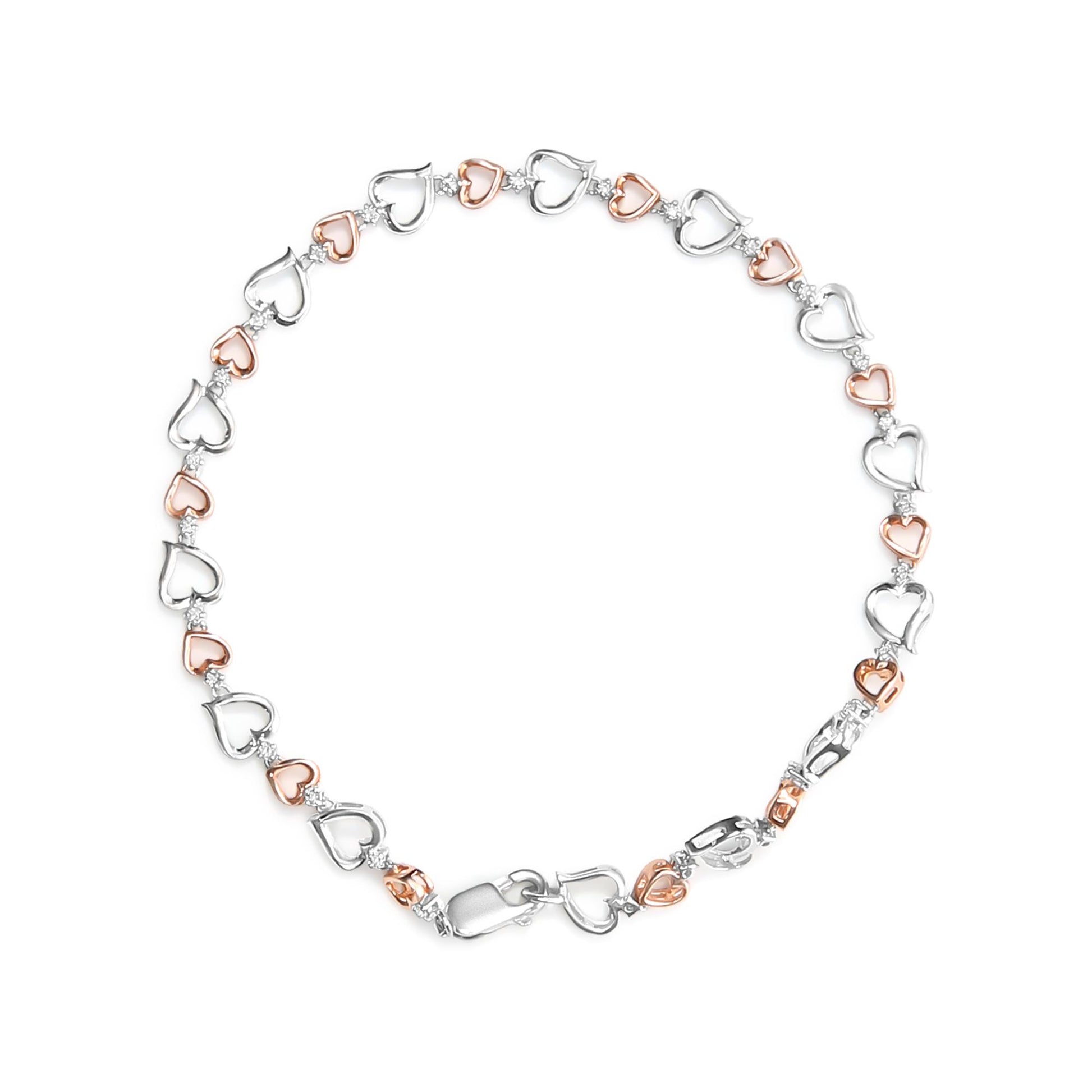 Top-down view of a white and rose metal heart-link bracelet accented with white round prong-set gemstones.