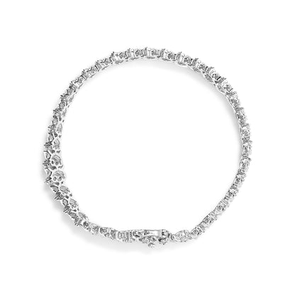 Top-down view of a white metal bracelet featuring two rows of round white gemstones in a miracle setting.