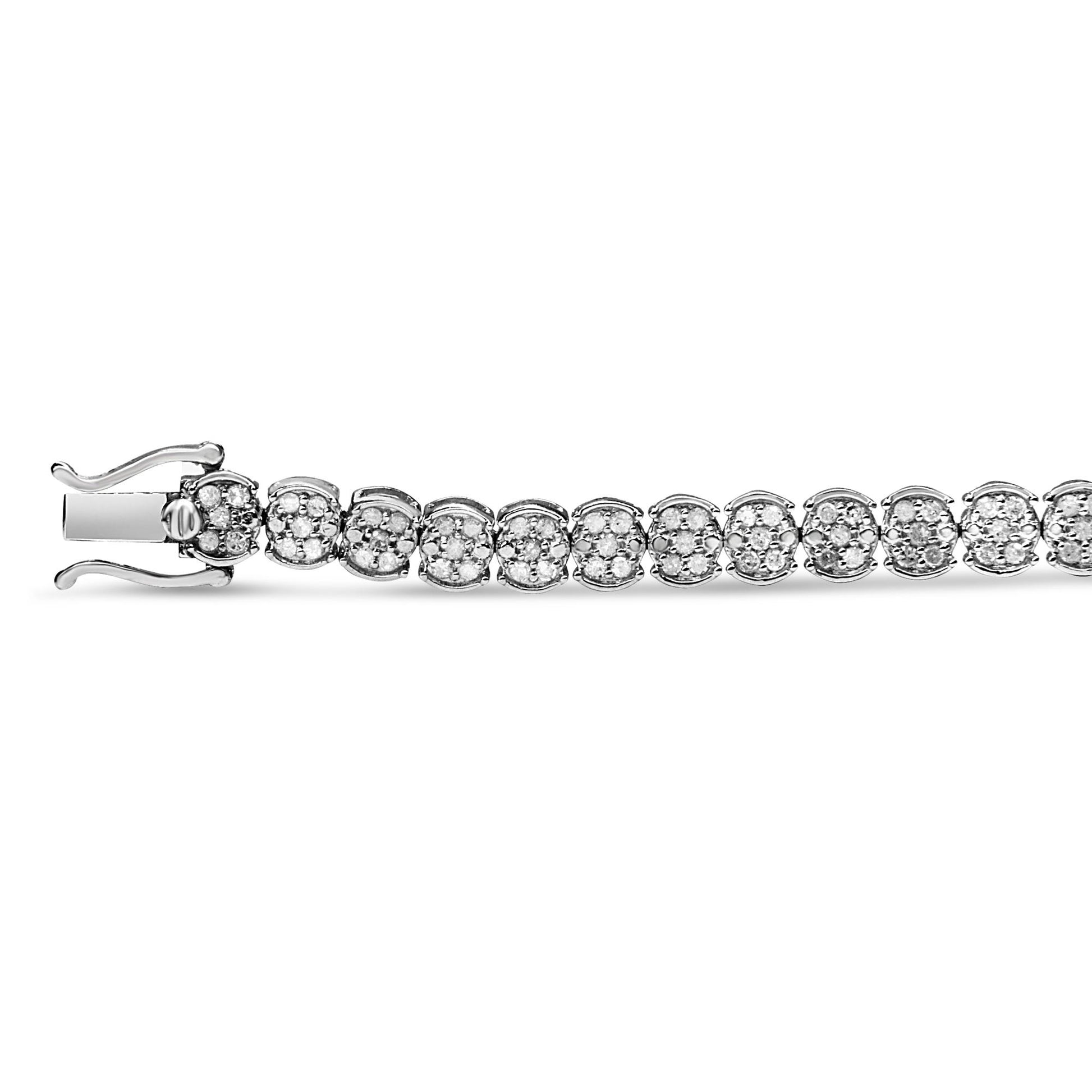 Close-up side angled shot of a white metal bracelet featuring round white gemstones in prong settings arranged in square clusters along the length.