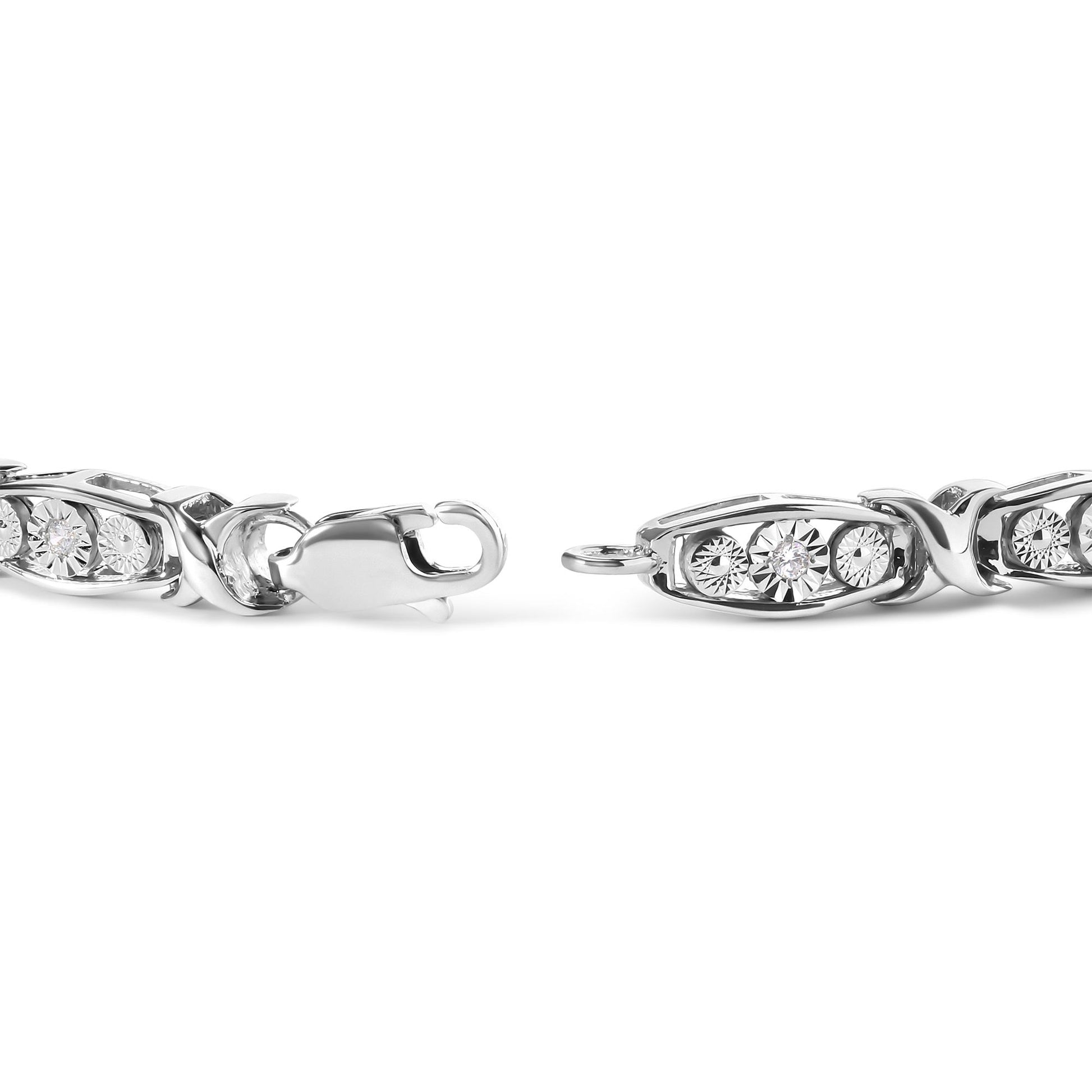 Close-up front angle of white metal bracelet with oval links featuring round white gemstones in miracle setting, and a lobster clasp.