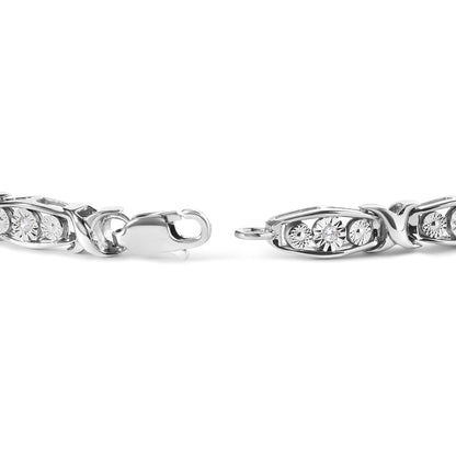 Close-up front angle of white metal bracelet with oval links featuring round white gemstones in miracle setting, and a lobster clasp.