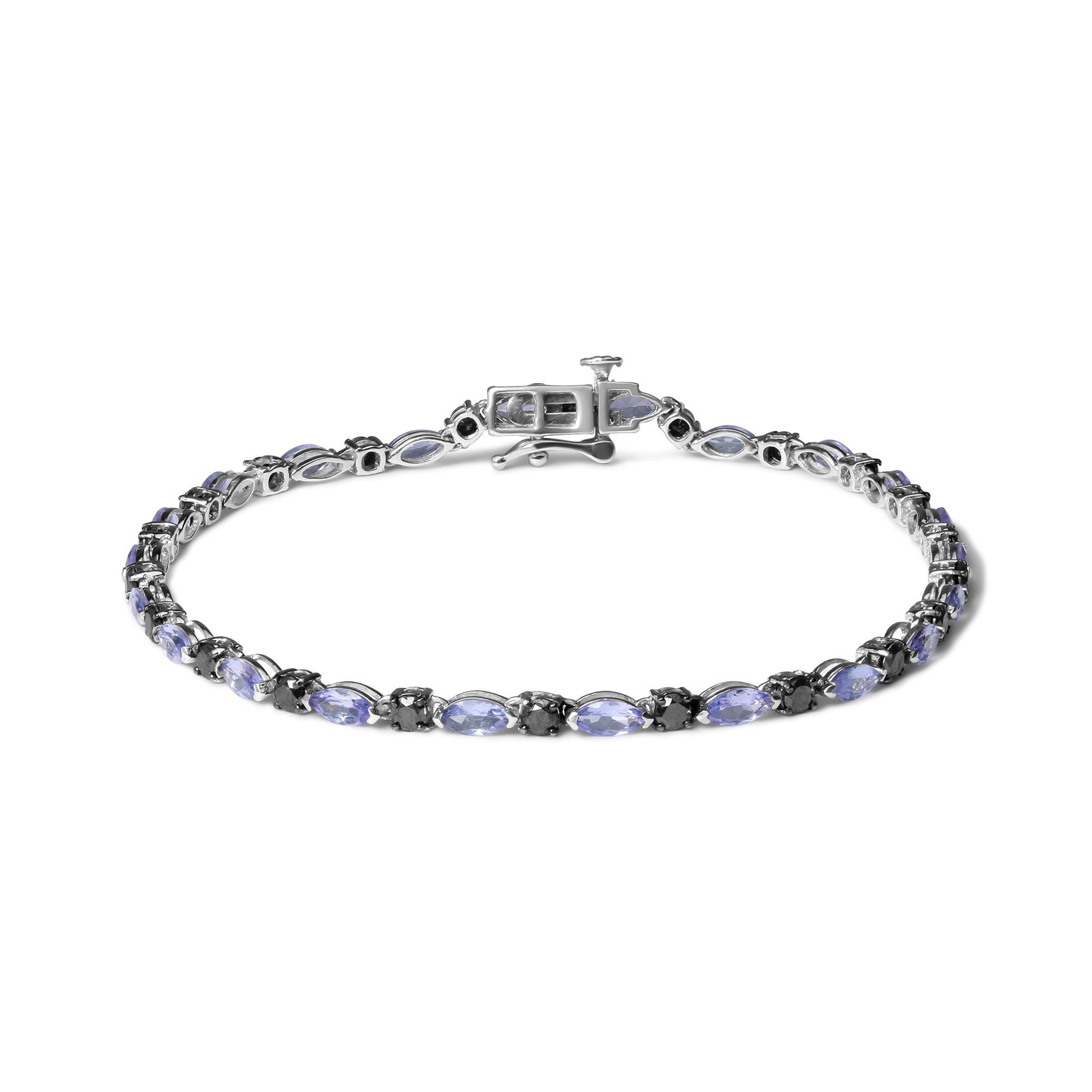 White metal bracelet viewed from above, featuring alternating blue marquise-shaped gemstones and round black gemstones in prong settings.