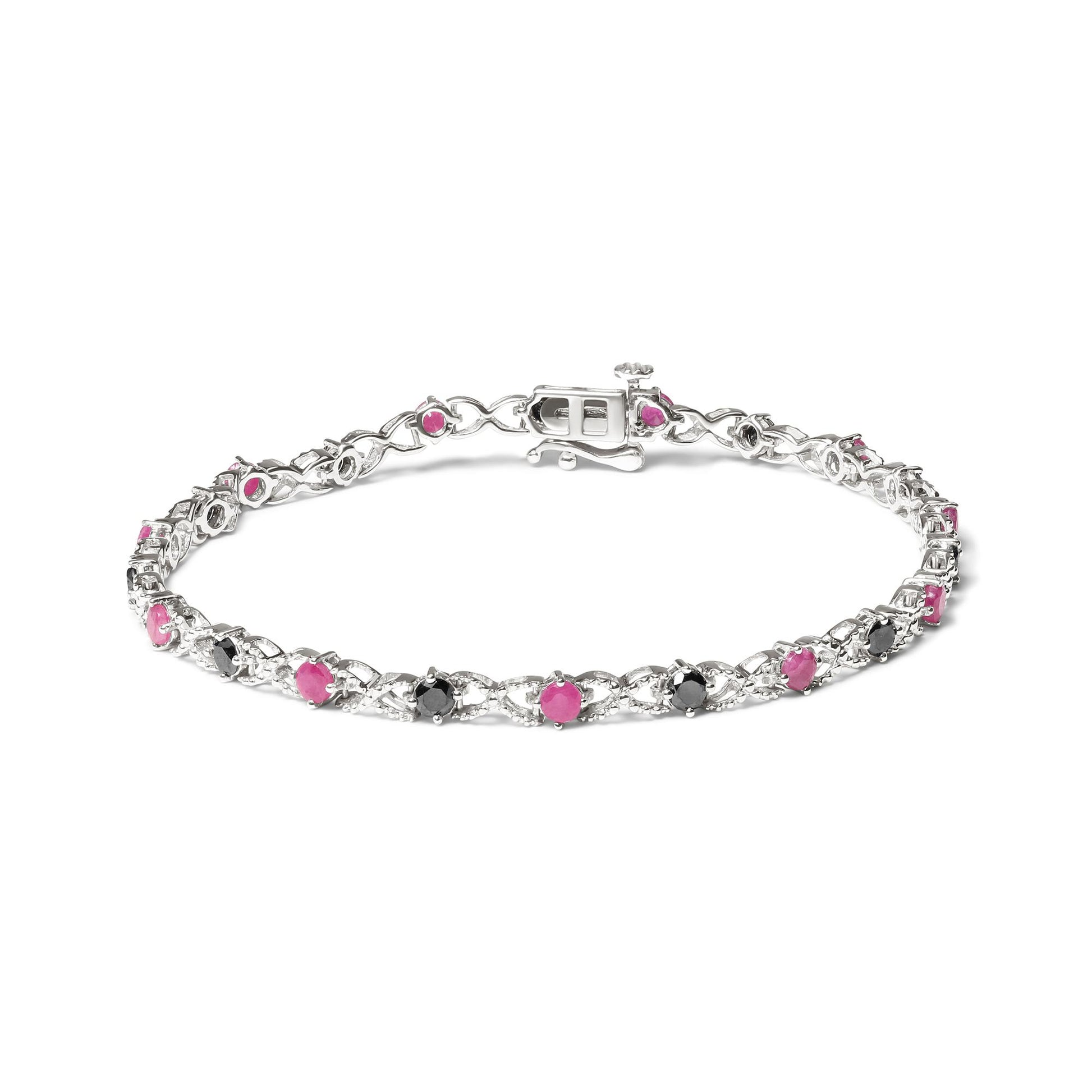 White bracelet with alternating round pink and black gemstones in prong settings, shown from an angled top view.
