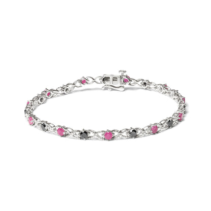 White bracelet with alternating round pink and black gemstones in prong settings, shown from an angled top view.