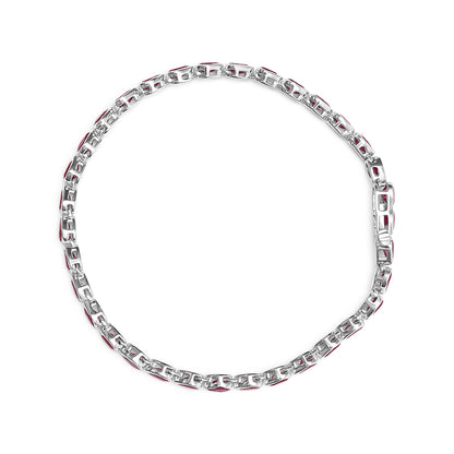 Top-down view of a white metal bracelet with alternating links featuring red gemstones, laid flat on a white background.