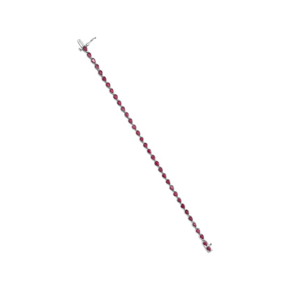 White metal bracelet with a series of red teardrop-shaped gemstones, shown flat from a top-down angle.