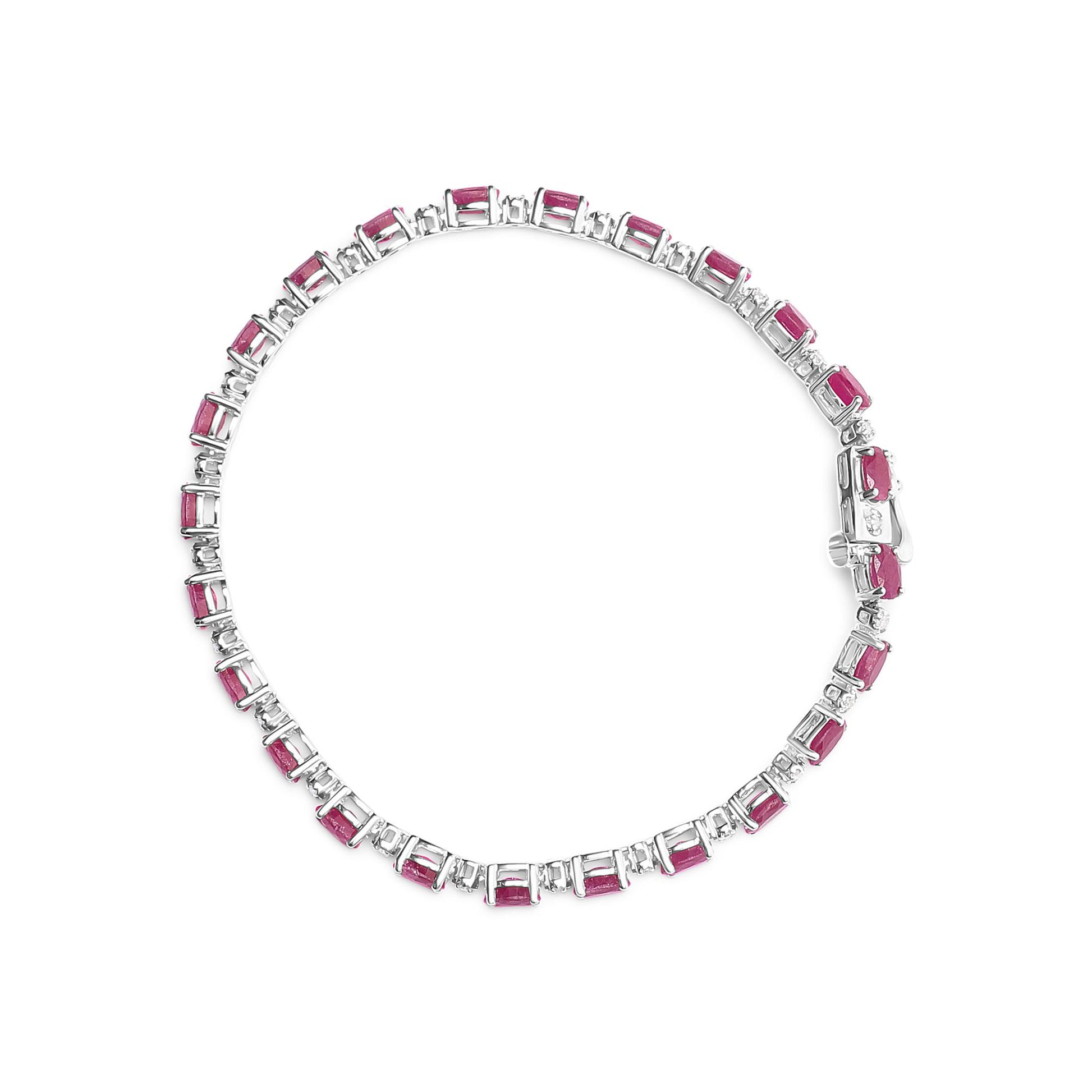 Top-down view of a white metal bracelet featuring alternating rectangular red gemstones and round white gemstones in prong settings.