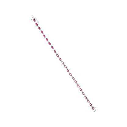 White metal bracelet with alternating red and white gemstones in prong settings, shown from a top-down angle.