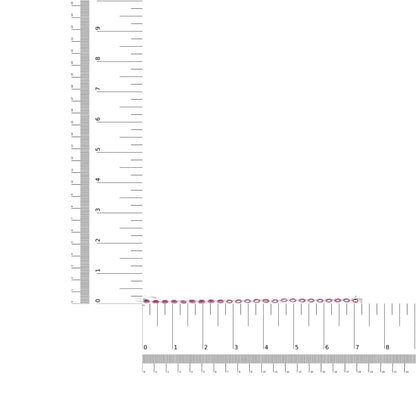Top-down view of a white metal bracelet with alternating red and white gemstones in prong settings, placed on two rulers for size reference.