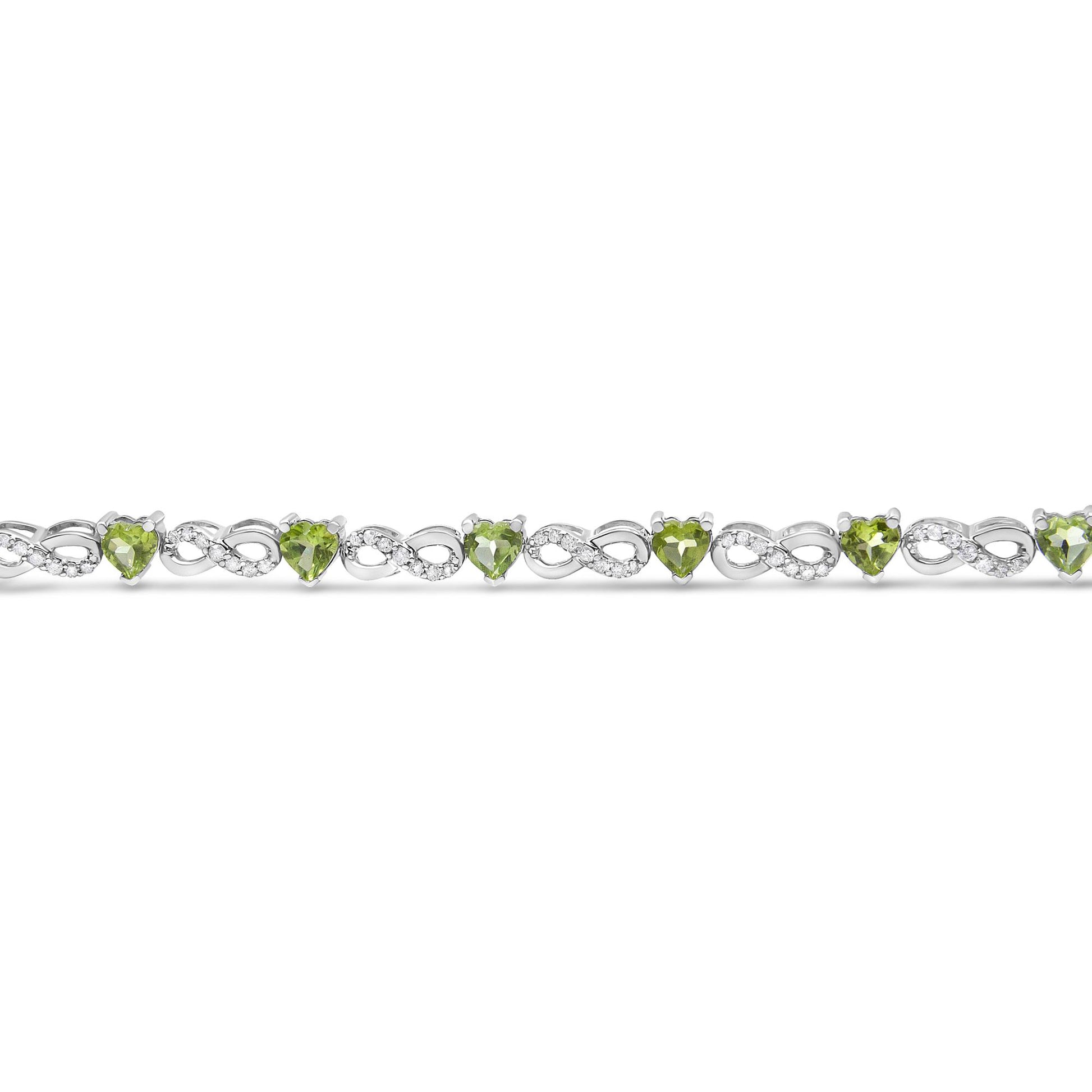 Front angle view of a white bracelet featuring alternating round white gemstones in prong settings and heart-shaped green gemstones in three-prong settings.