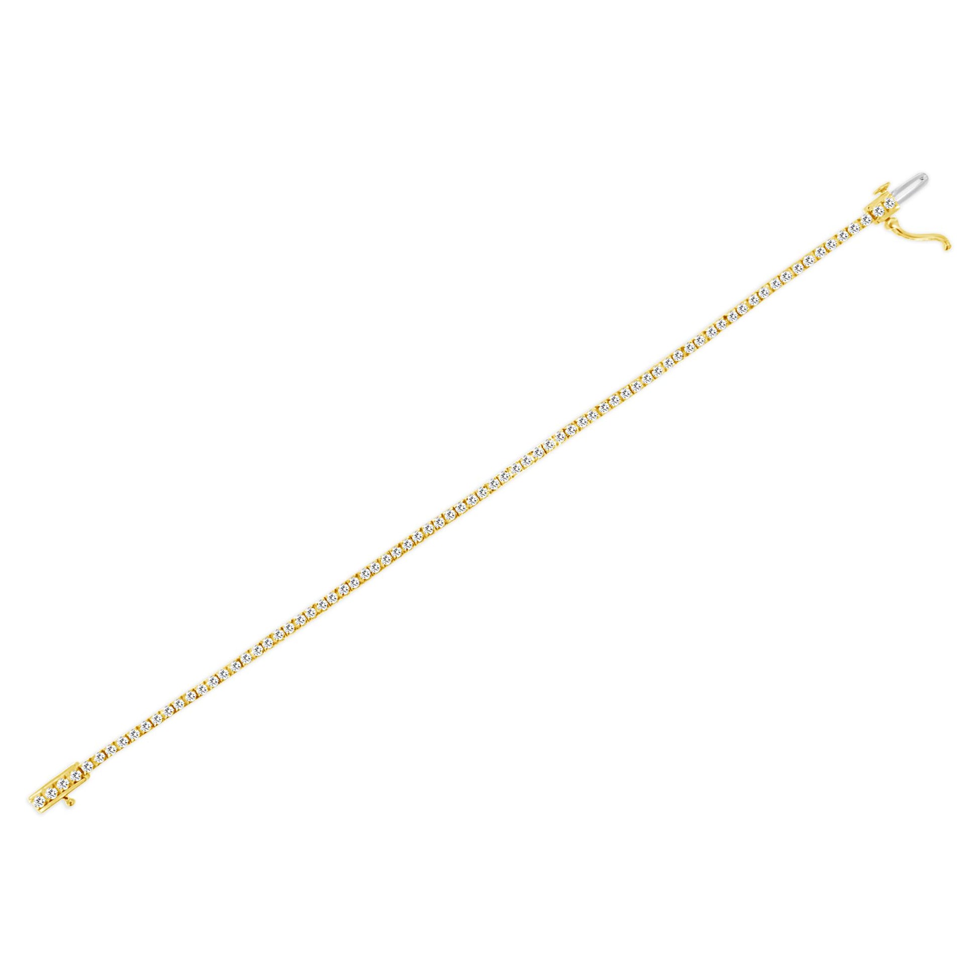 Yellow metal bracelet with white round gemstones in prong settings, shown flat in a top-down angled view.