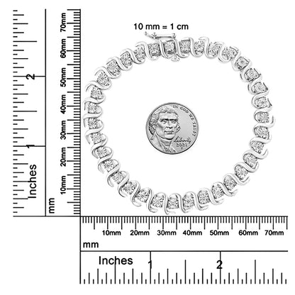Top-down view of a white bracelet set with round white gemstones in a wavy design, displayed next to a coin and rulers for size reference.