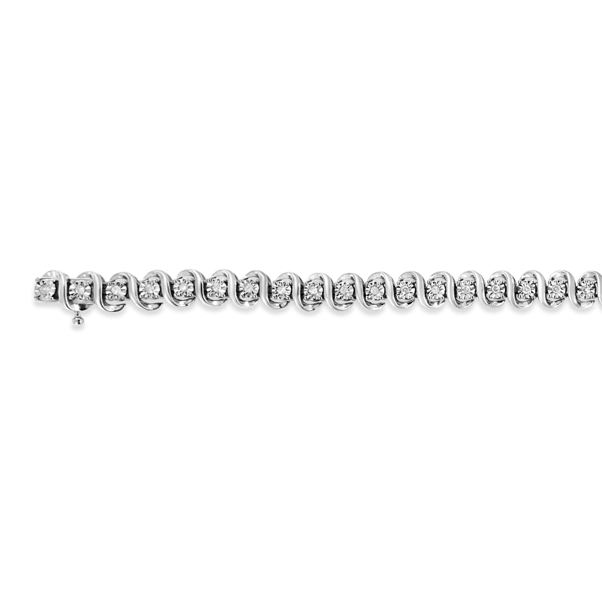 Top-down close-up of a white metal bracelet with round white gemstones in a miracle setting along its length.