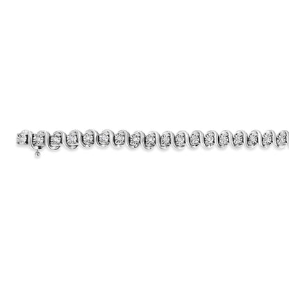 Top-down close-up of a white metal bracelet with round white gemstones in a miracle setting along its length.