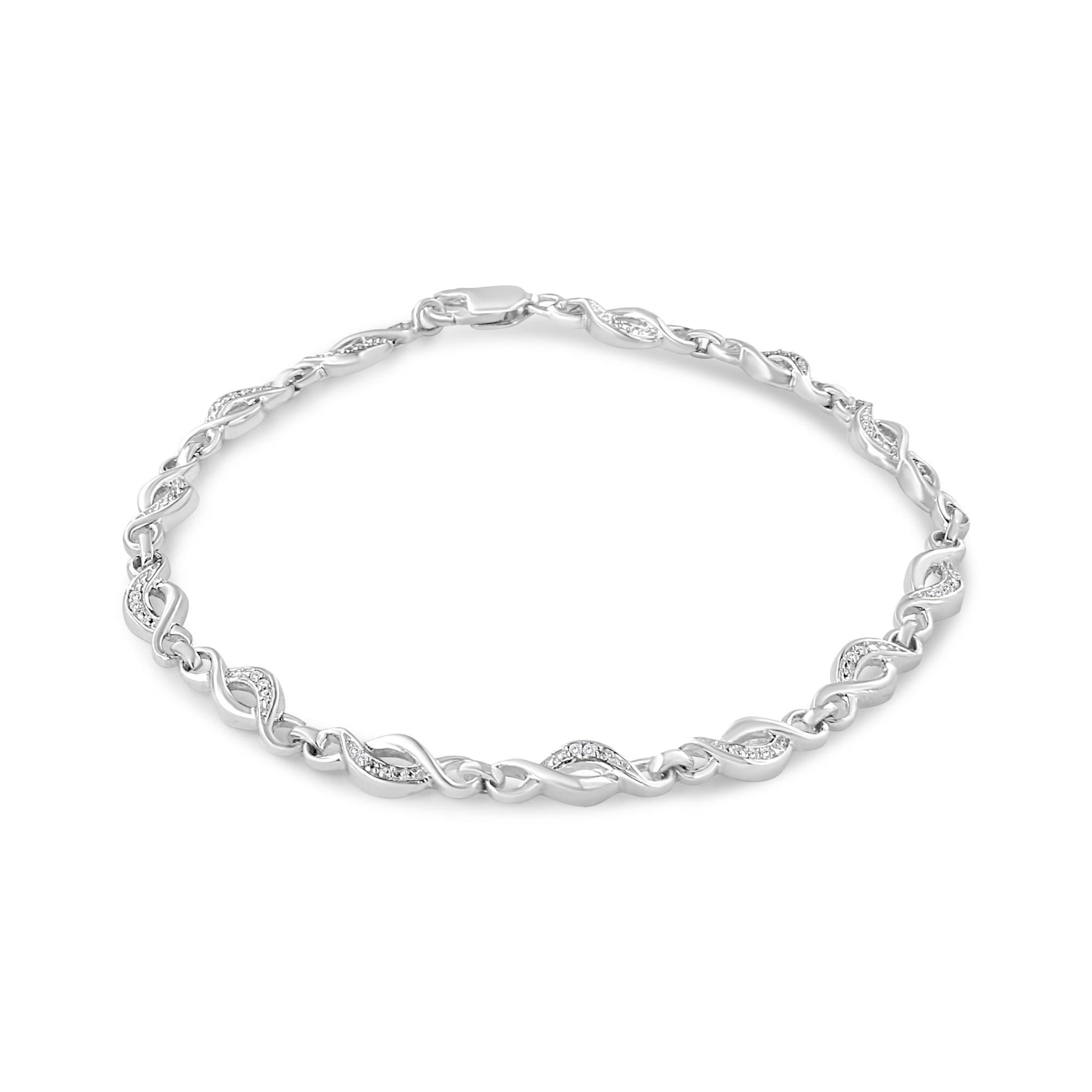White metal bracelet with alternating twisted links and links set with small white gemstones, shown from a top front angle.